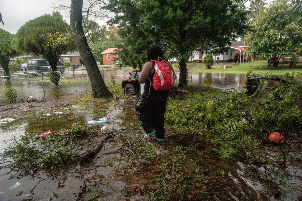 Sharon Langley returned home to gather a few belongings after being evacuated as floodwaters rose early Friday morning in Was