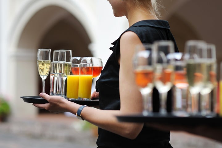 waiter with dish of champagne ...