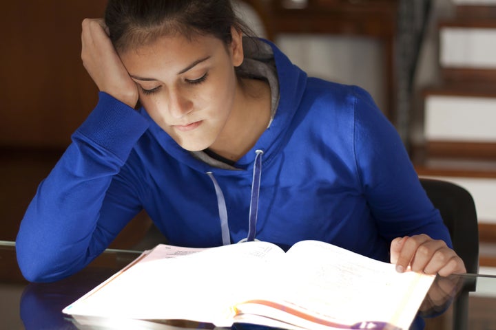 tired listless girl studying a ...