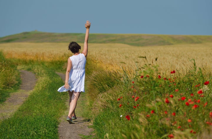 young woman standing jumping...