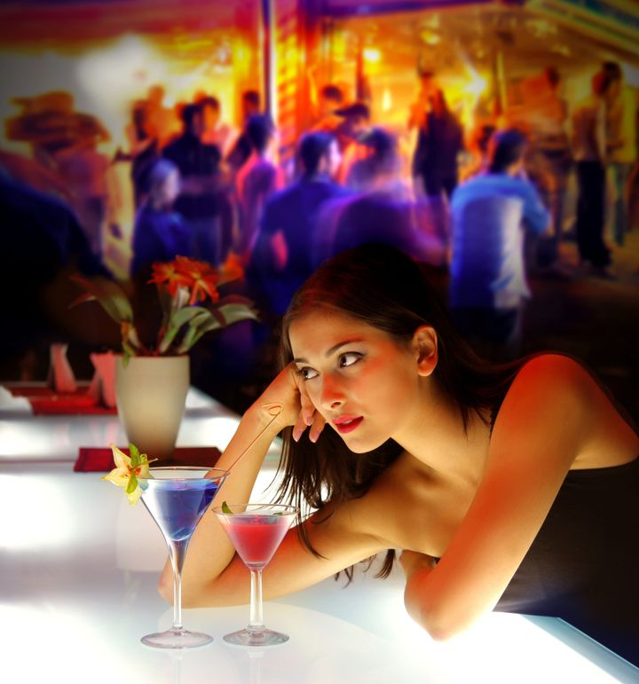 woman drinking cocktail during a party