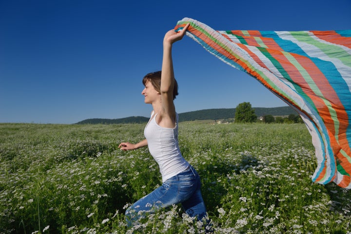 young woman standing jumping...