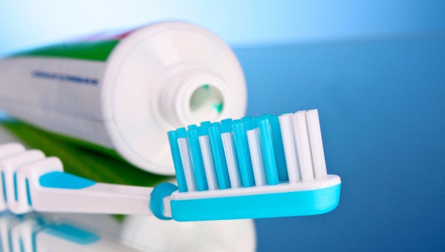 toothpaste and brush on a blue background