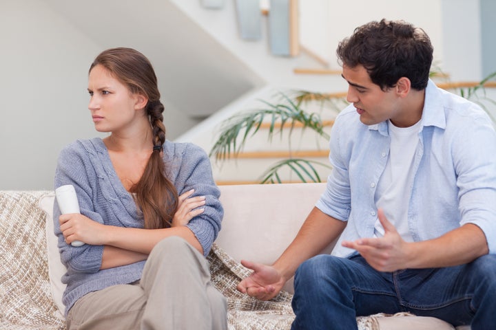 Man arguing with his wife in their living room