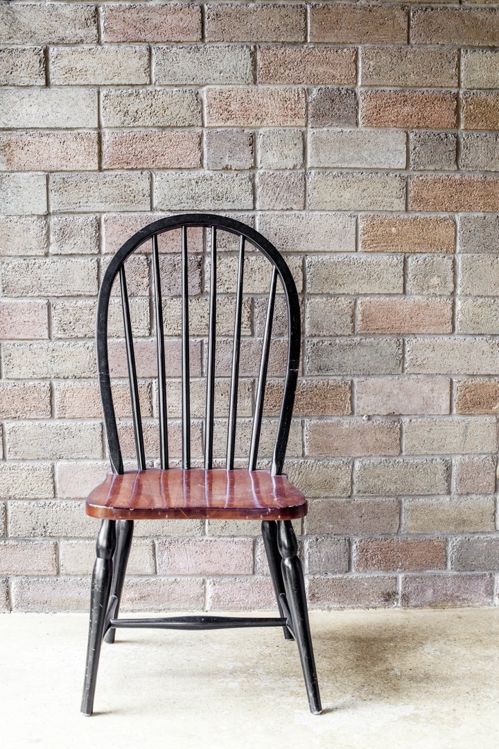 black chair in front of a brick ...