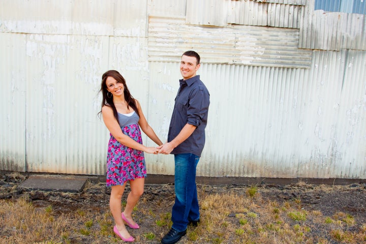 A young couple poses for some engagement photos in urban outdoor settings.