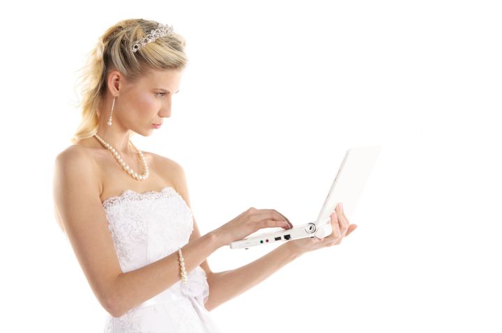 beautiful bride with laptop isolated on white