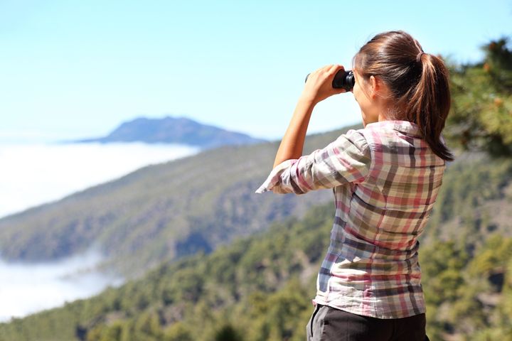 hiker looking in binoculars...