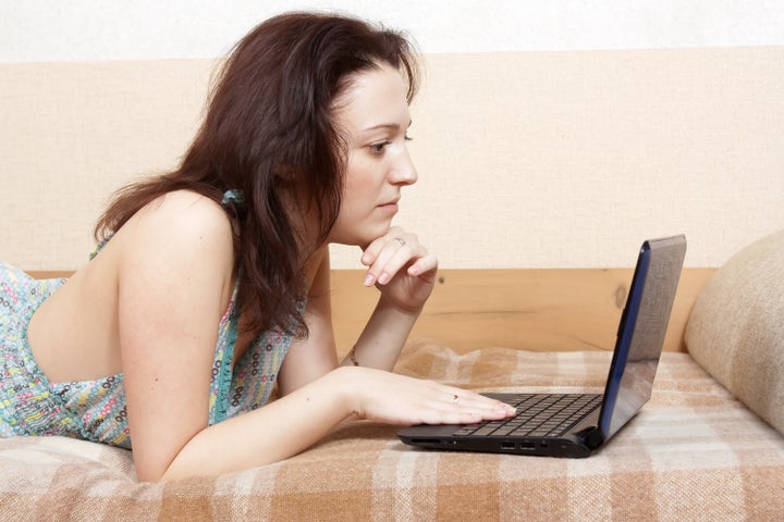 Portrait of young woman using laptop