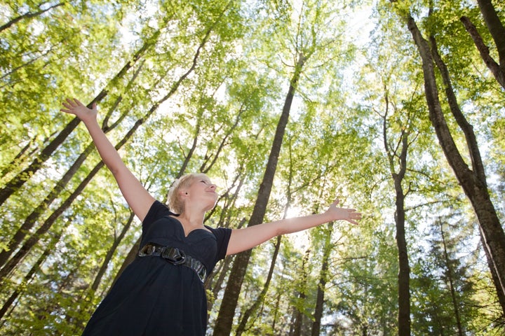 young woman with arms raised...