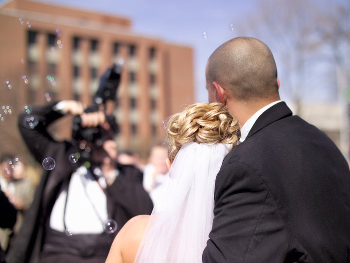 A real wedding couple and photographer. Bubbles filled the air. (Real wedding, 14MP camera)
