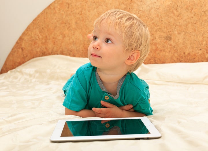 baby with touch pad at home