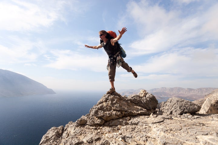 young man standing on a rock...