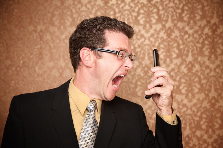 Angry Business Man Shouting at His Phone