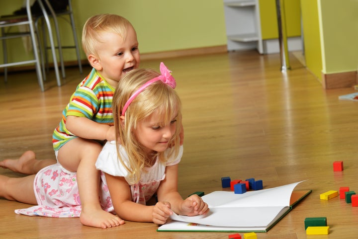 little boy with his sister playing at home