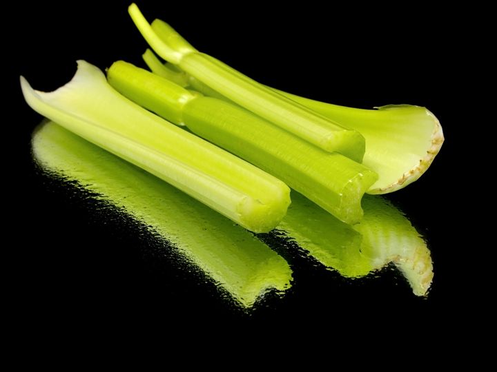fresh celery on a black...