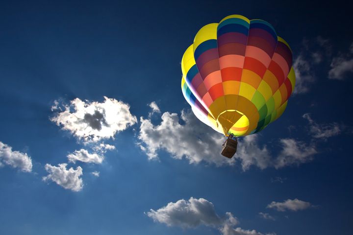 Hot air balloon in the blue sky and clouds