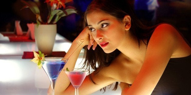 woman drinking cocktail during a party