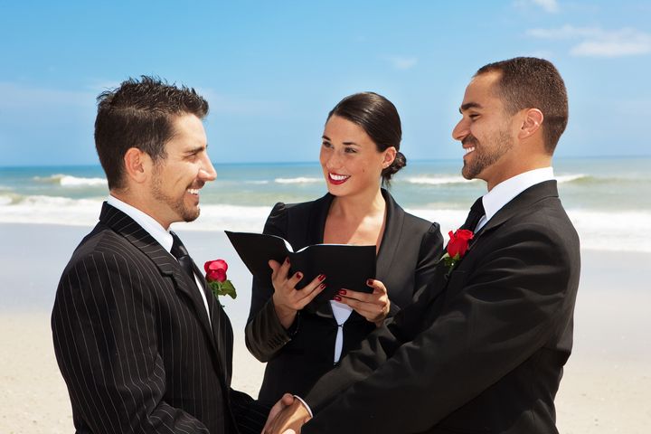 Gay couple getting married on a beach