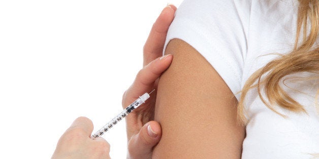 Doctor hand make patient insulin flu shot by syringe subcutaneous arm injection vaccination isolated on a white background