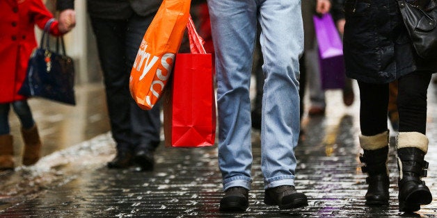 Pedestrians carry shopping bags in the Covent Garden district of London, U.K., on Monday, Dec. 31, 2012. The number of Britons making shopping trips for post-holiday bargains barely increased on the day after Christmas as more people sought discounts online. Photographer: Jason Alden/Bloomberg via Getty Images