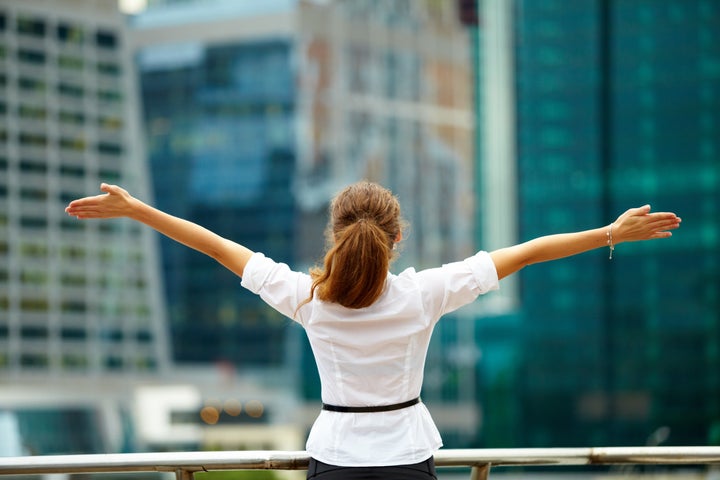 Portrait of cute young business woman outdoor with hands spread