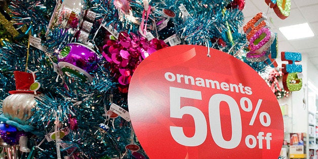 A shopper passes by a 50% off sign displayed in a J.C. Penney Co. Inc. store at the King of Prussia Mall in King of Prussia, Pennsylvania, U.S., on Friday, Nov. 25, 2011. Black Friday, traditionally the biggest U.S. shopping day of the year, got off to its earliest start ever as retailers tried to woo shoppers with discounts and early store openings. Photographer: Paul Taggart/Bloomberg via Getty Images