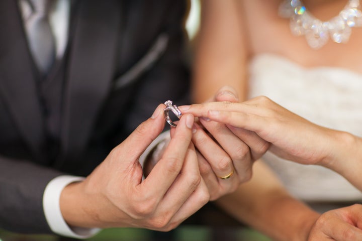 Close up Groom Put the Wedding Ring on bride