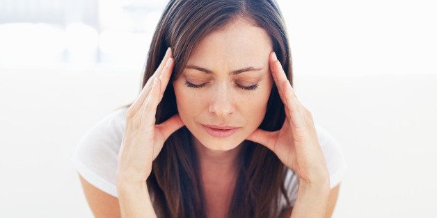 Portrait of stressed woman having head pain