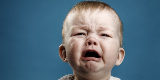 Photo of nine month baby crying, isolated