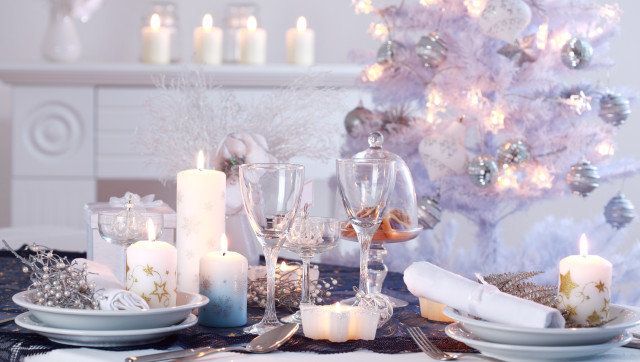 Place setting for Christmas in white with white Christmas tree