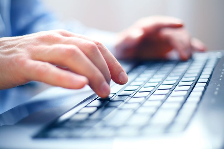 Image of man's hands typing. Selective focus