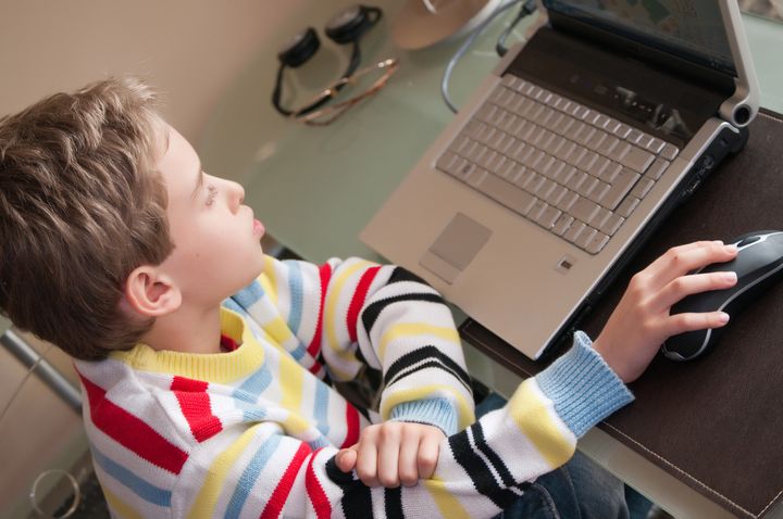 young boy using laptop