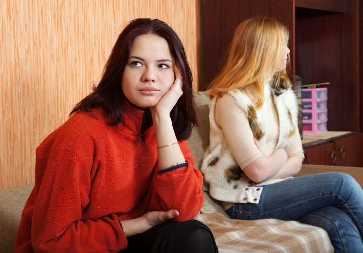 two sad girls having quarrel at ...