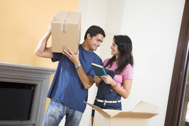 Young happy couple moving boxes at home