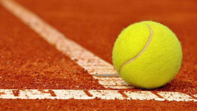 Tennis ball on a tennis clay court