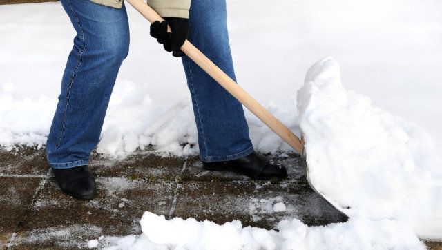 Woman is shovelling snow