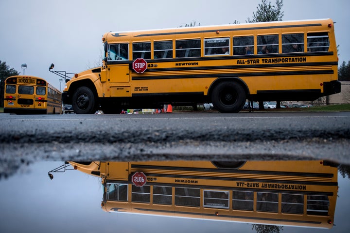 A school bus takes students to Newtown High School December 18, 2012 in Newtown, Connecticut. Students in Newtown, excluding