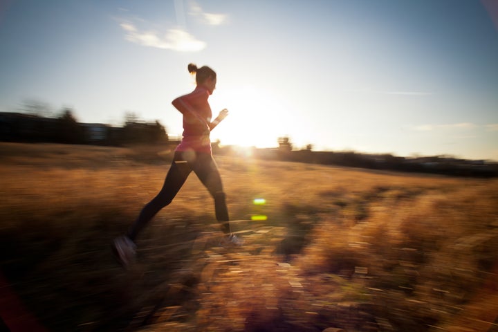 young woman running outdoors on ...