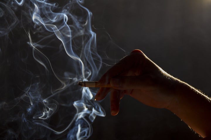 hand with smoking cigarette...