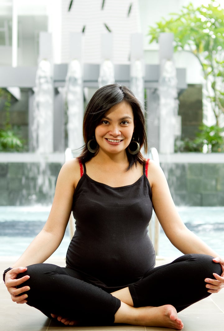 Asian ethnic pregnant woman exercise by the pool