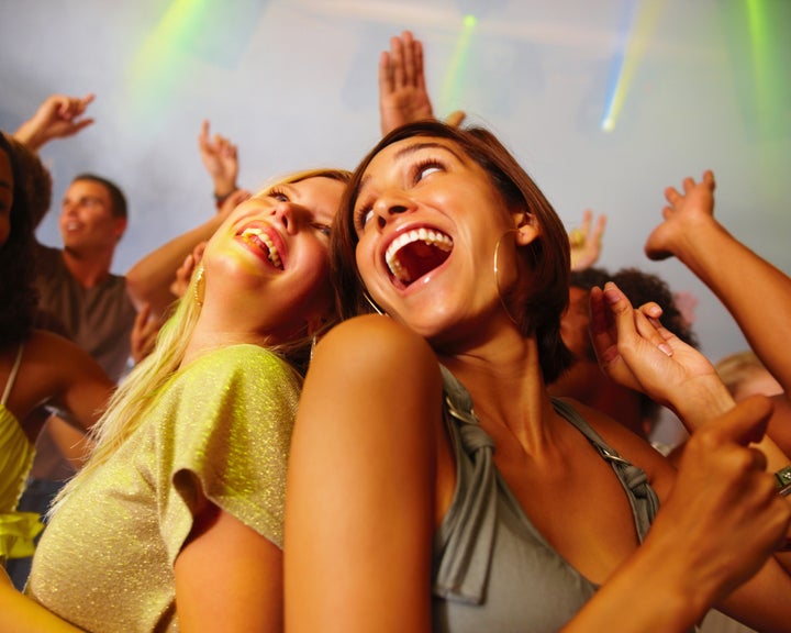 Closeup of laughing young girls enjoying at nightclub