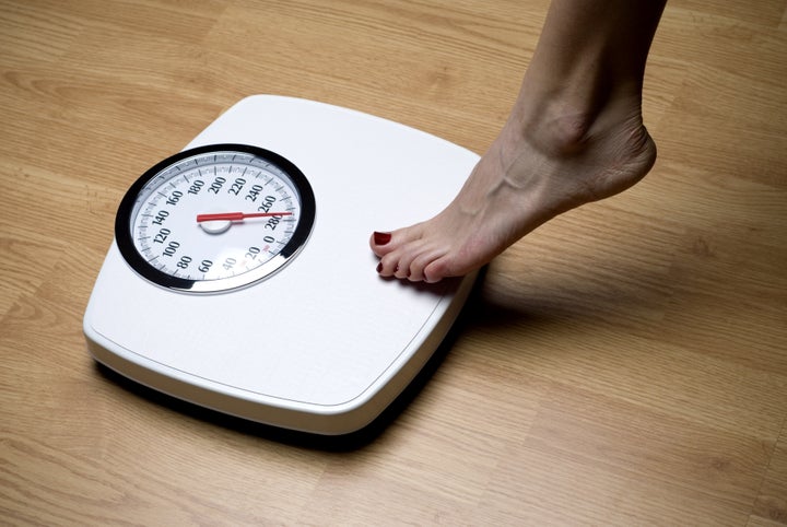 woman's foot on bathroom scale