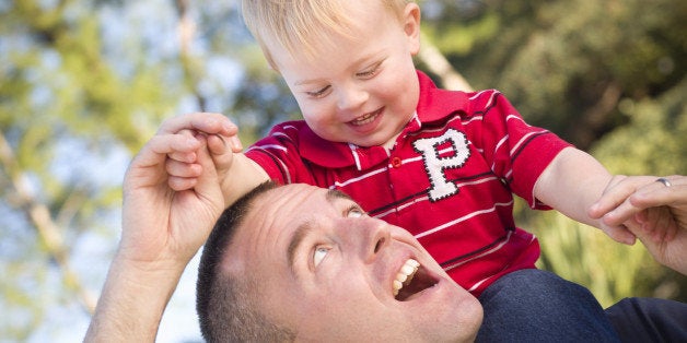 young laughing father and child ...