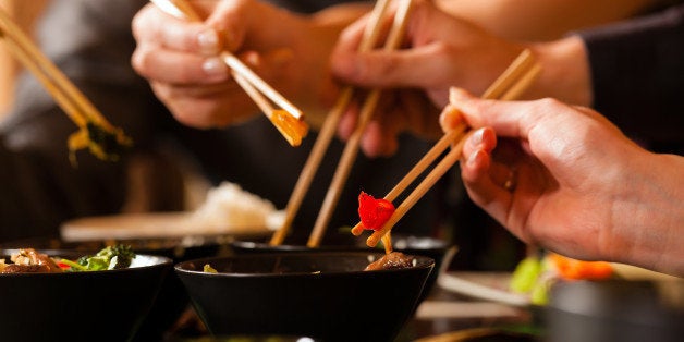 young people eating in a thai...