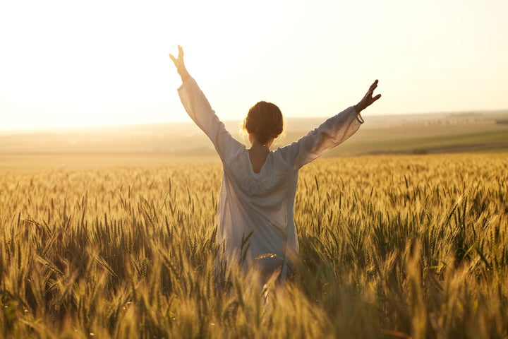 woman with arms outstretched in ...