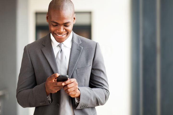 young african american businessman reading email on smart phone