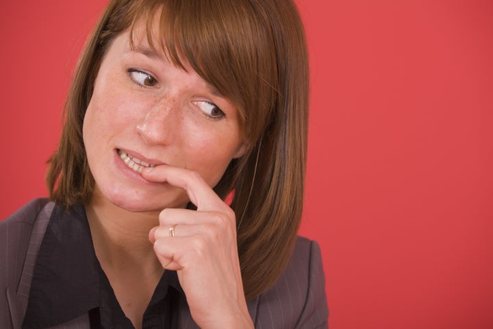 nervous businesswoman biting...