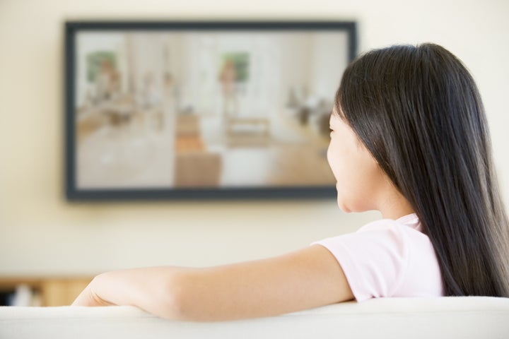 Young girl in living room with flat screen television