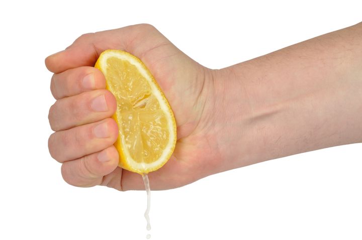 hand squeezing lemon isolated...